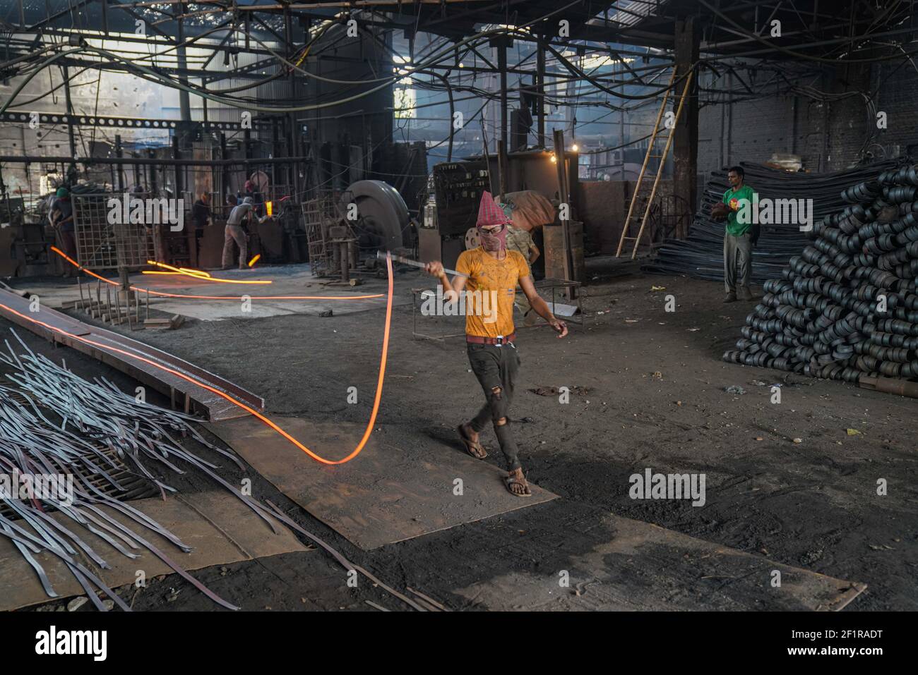 Dhaka, Dhaka, Bangladesh. 9th Mar, 2021. A rolling mill worker seen working in the steel re-rolling mill without proper safety gear or tools in Dhaka, Bangladesh on March 9, 2021. Credit: Zabed Hasnain Chowdhury/ZUMA Wire/Alamy Live News Stock Photo