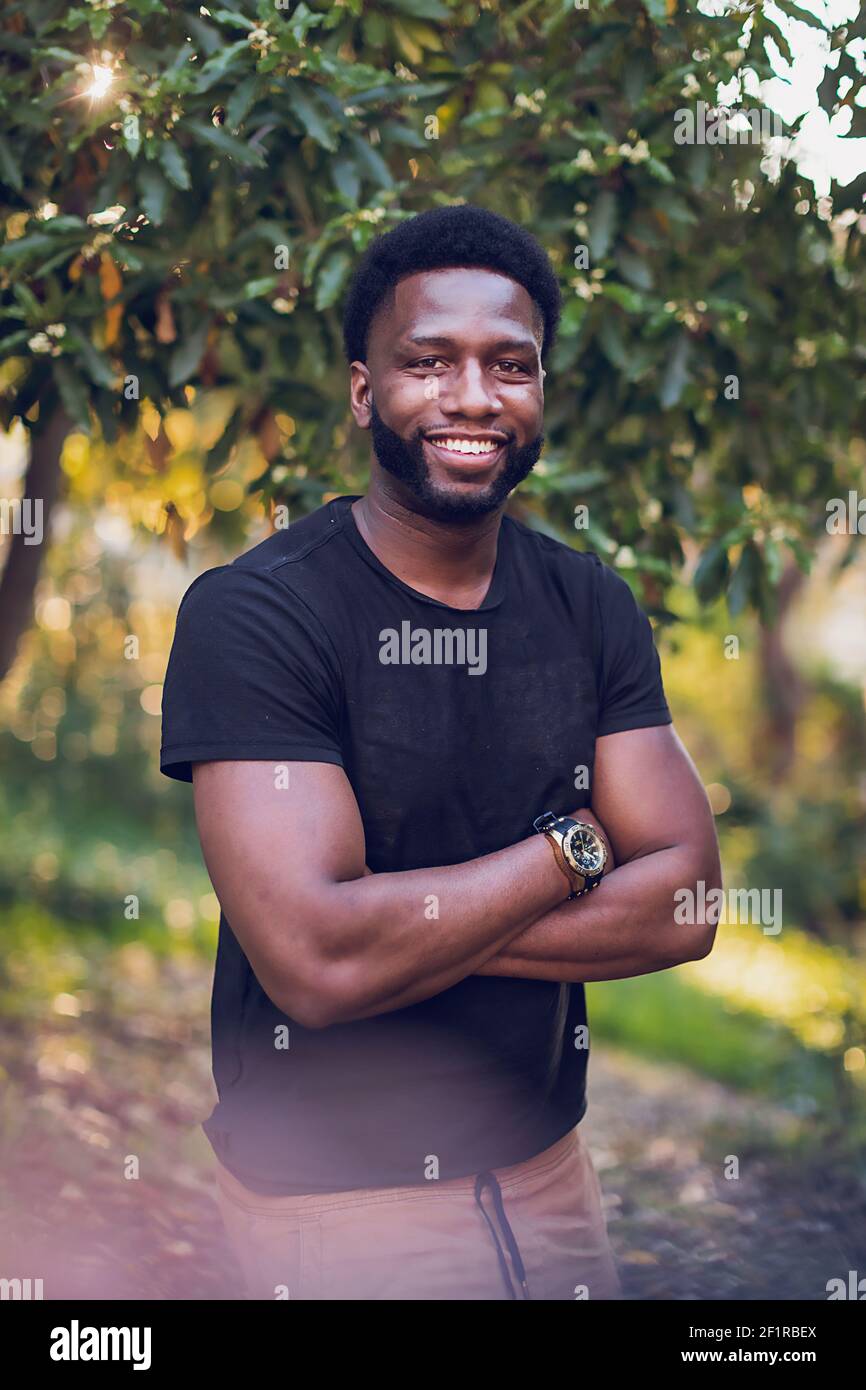 Headshot of a young black man with arms crossed Stock Photo Alamy
