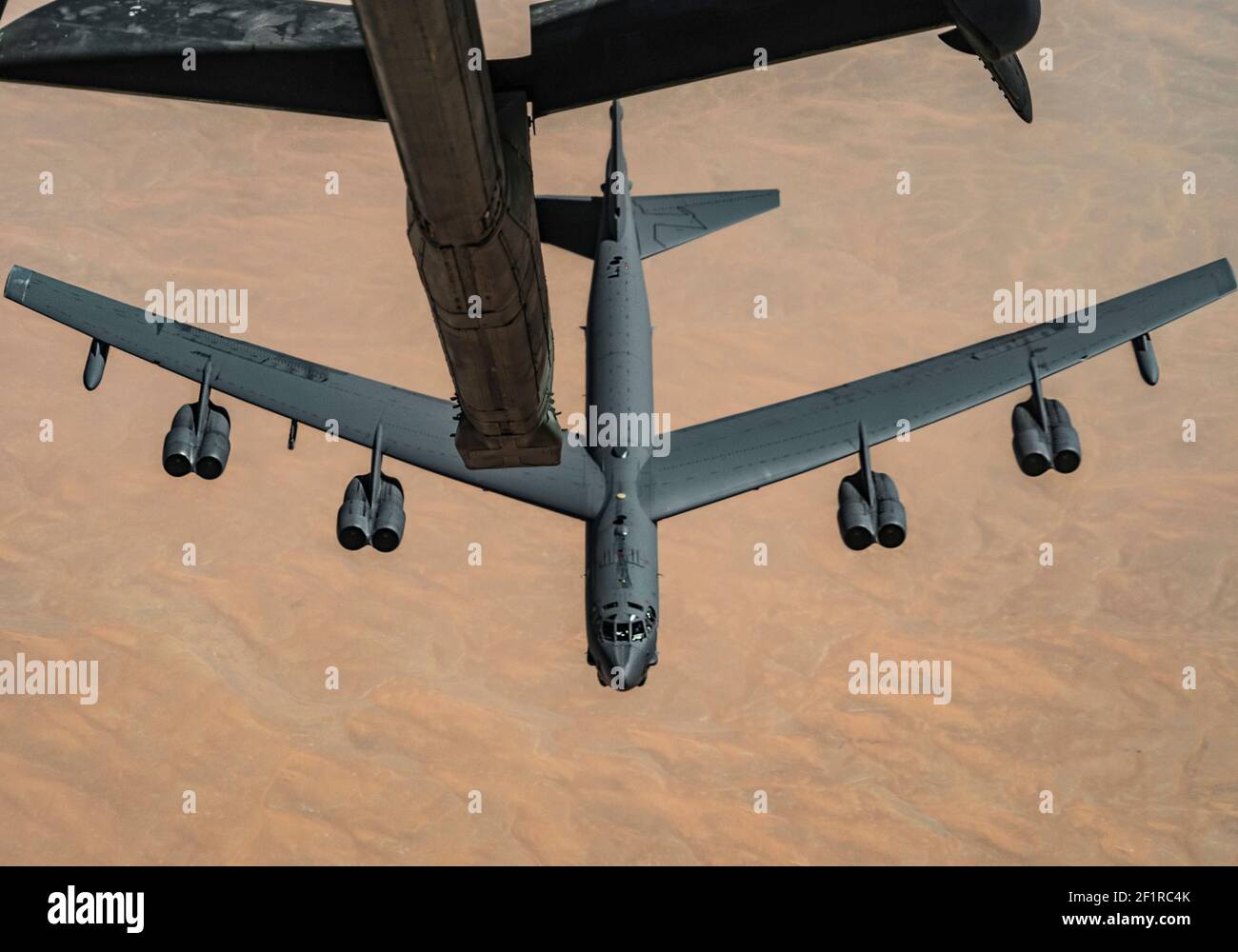 A U.S. Air Force B-52H Stratofortress strategic bomber assigned to the 5th Bomb Wing refuels from a KC-10 Extender assigned to the 908th Expeditionary Air Refueling Squadron March 7, 2021 over the Persian Gulf. The aircraft flew over the Persian Gulf to deter potential aggression by Iran. Stock Photo