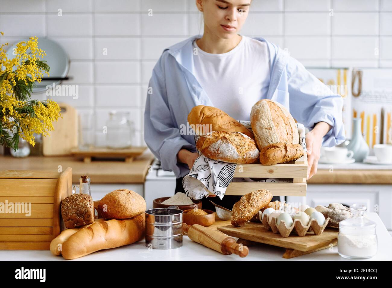 young girl holding bread in the kitchen Stock Photo Alamy