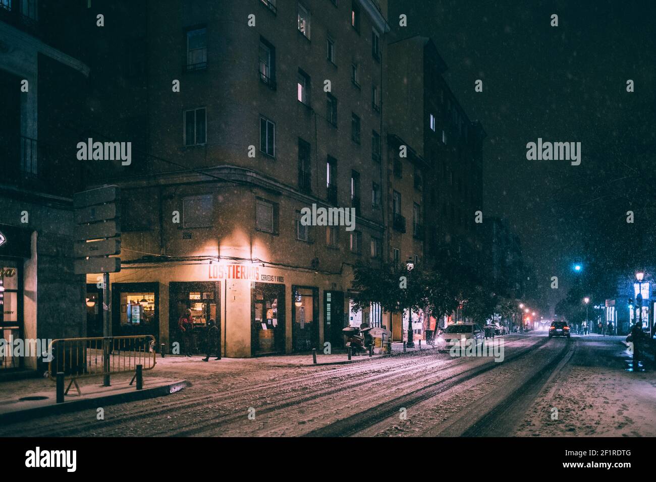 Cars driving carefully in snow covered roads at the city center of Madrid, Spain Stock Photo