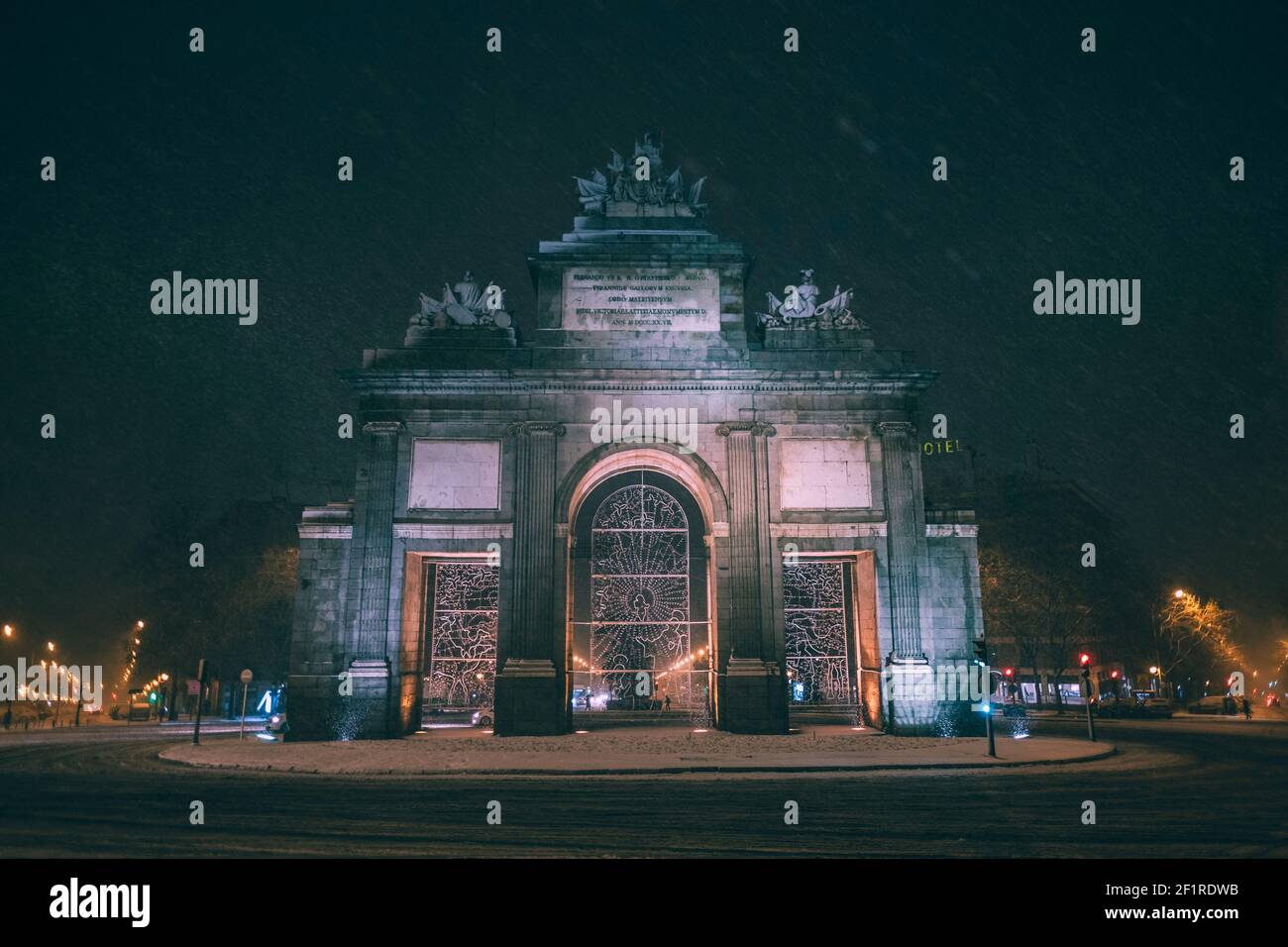 Puerta de Toledo iluminares at night while heavily snowing in Madrid, Spain Stock Photo