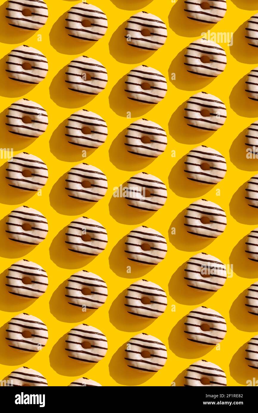a pattern on a yellow background of donuts Stock Photo