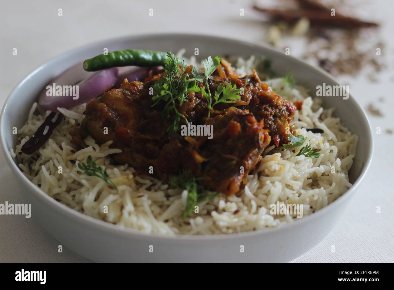 Jeera rice and chicken dry roast. A simple and flavourful one pot rice preparation with basic ingredients. shot on white background Stock Photo