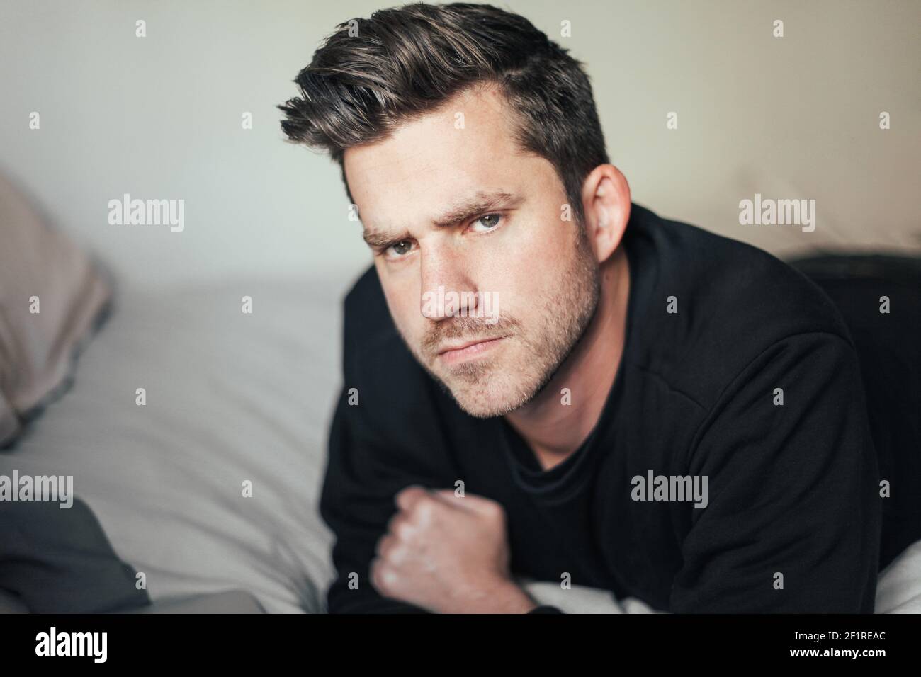 Handsome man looks serious and angry looking at the camera Stock Photo