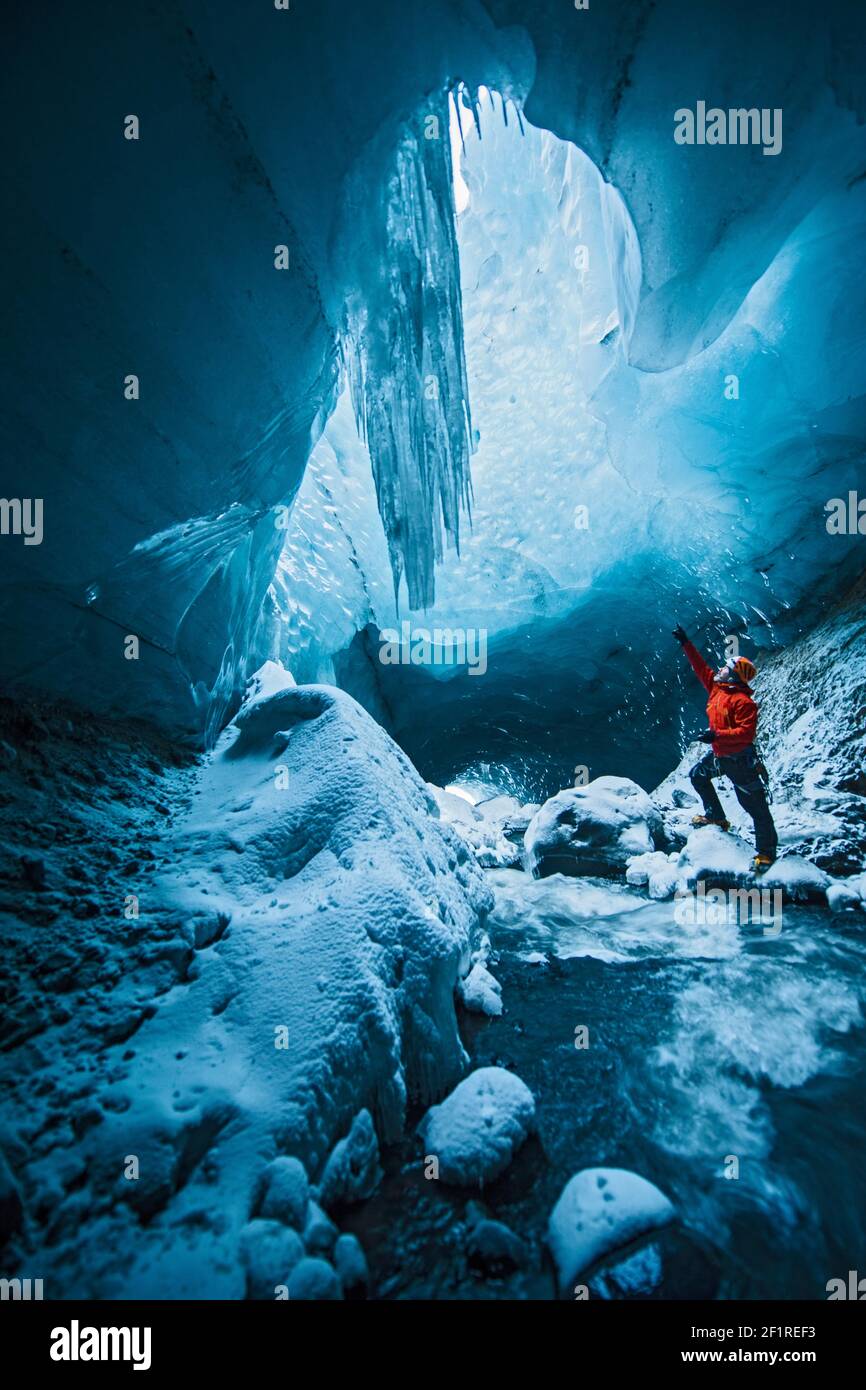 man exploring ice cave in Thórsmörk - Iceland Stock Photo