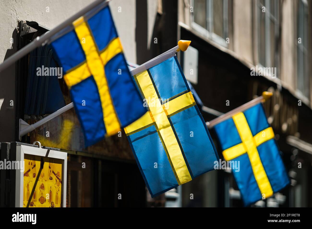 Swedish flags outside a shop on Västerlånggatan, Gamla Stan, Stockholm, Sweden. Stock Photo