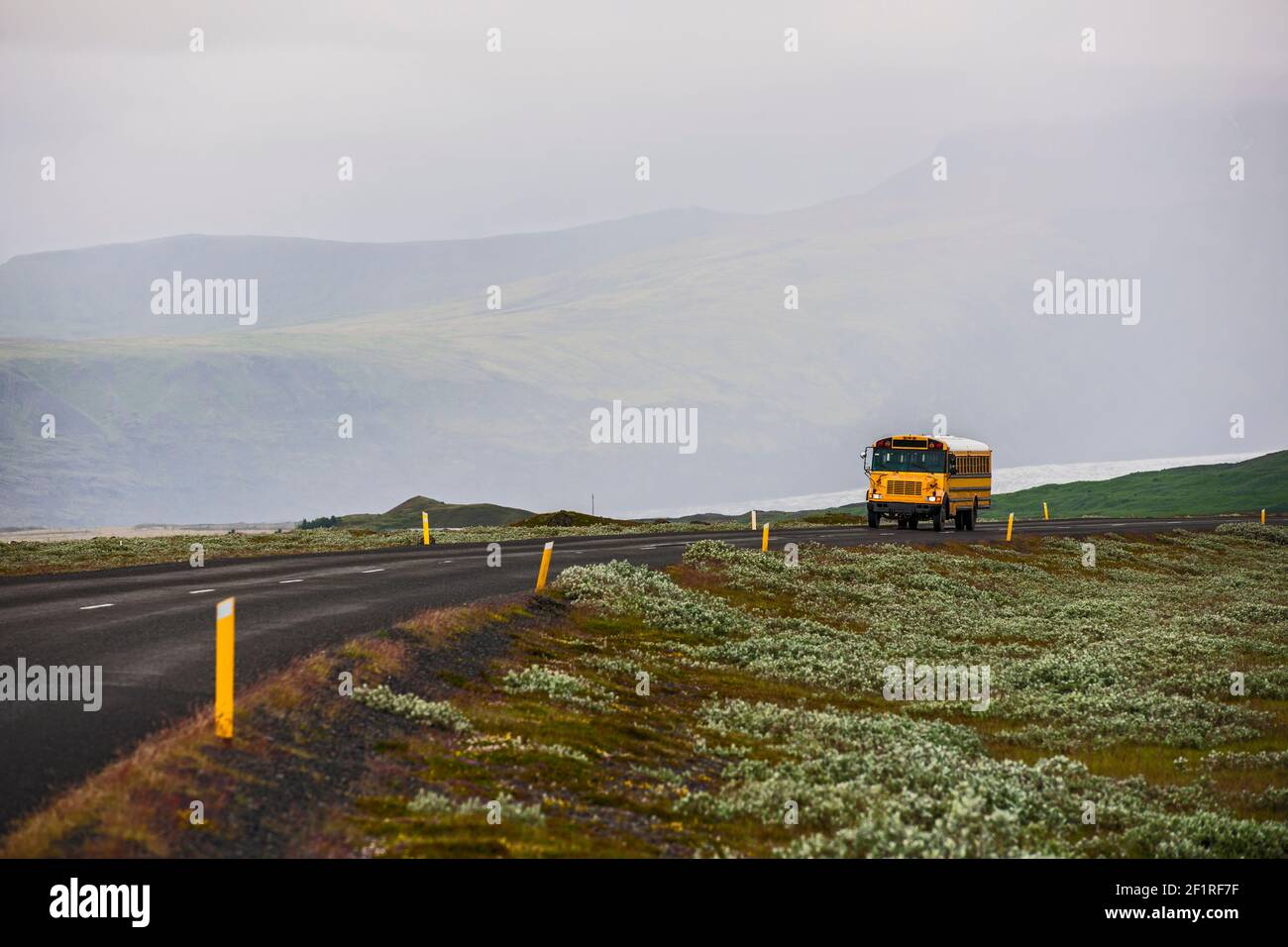 school bus on rural road in Iceland Stock Photo