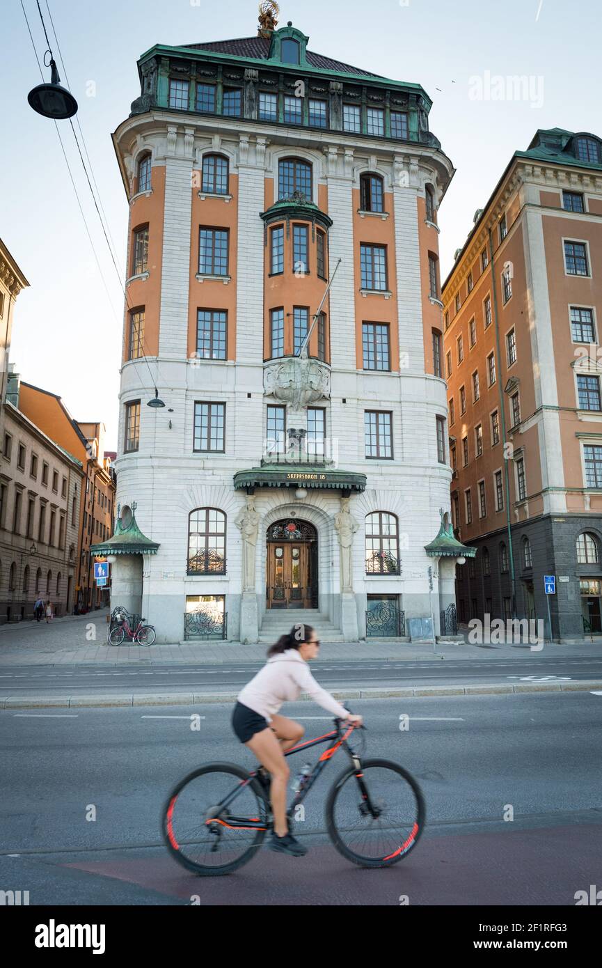 A cyclist on Skeppsbron, Gamla Stan, Stockholm, Sweden. Stock Photo