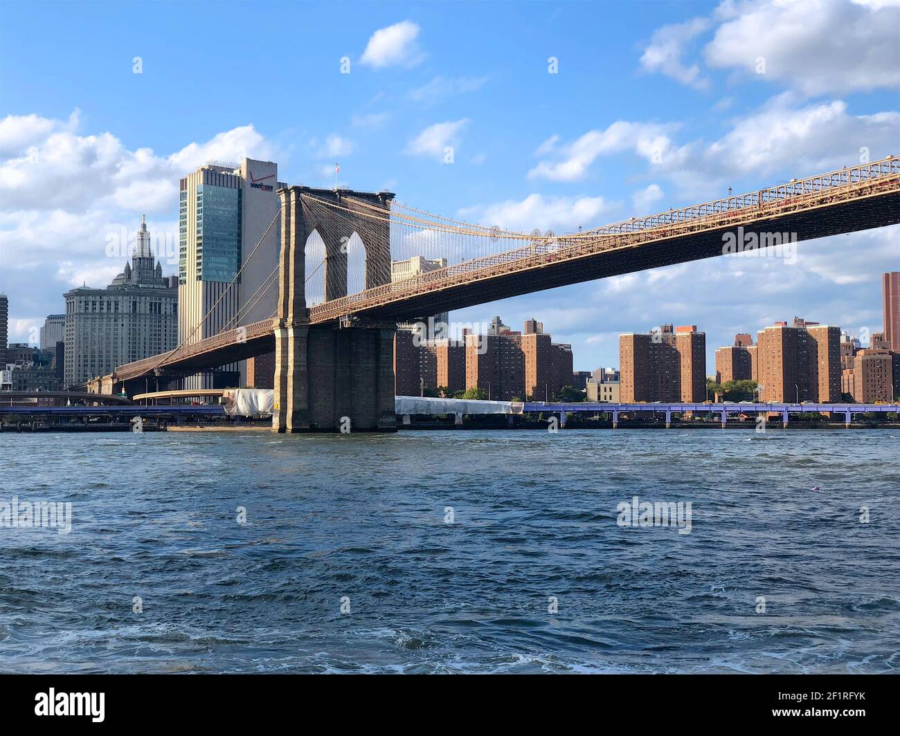 Brooklyn Bridge with Hudson river and Manhattan skyline, New York City downtown. Stock Photo
