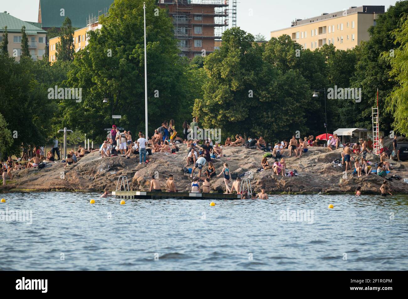 Sunbathers on Tanto strandbad, Skarpskyttestigen, Södermalm, Stockholm, Sweden. Stock Photo
