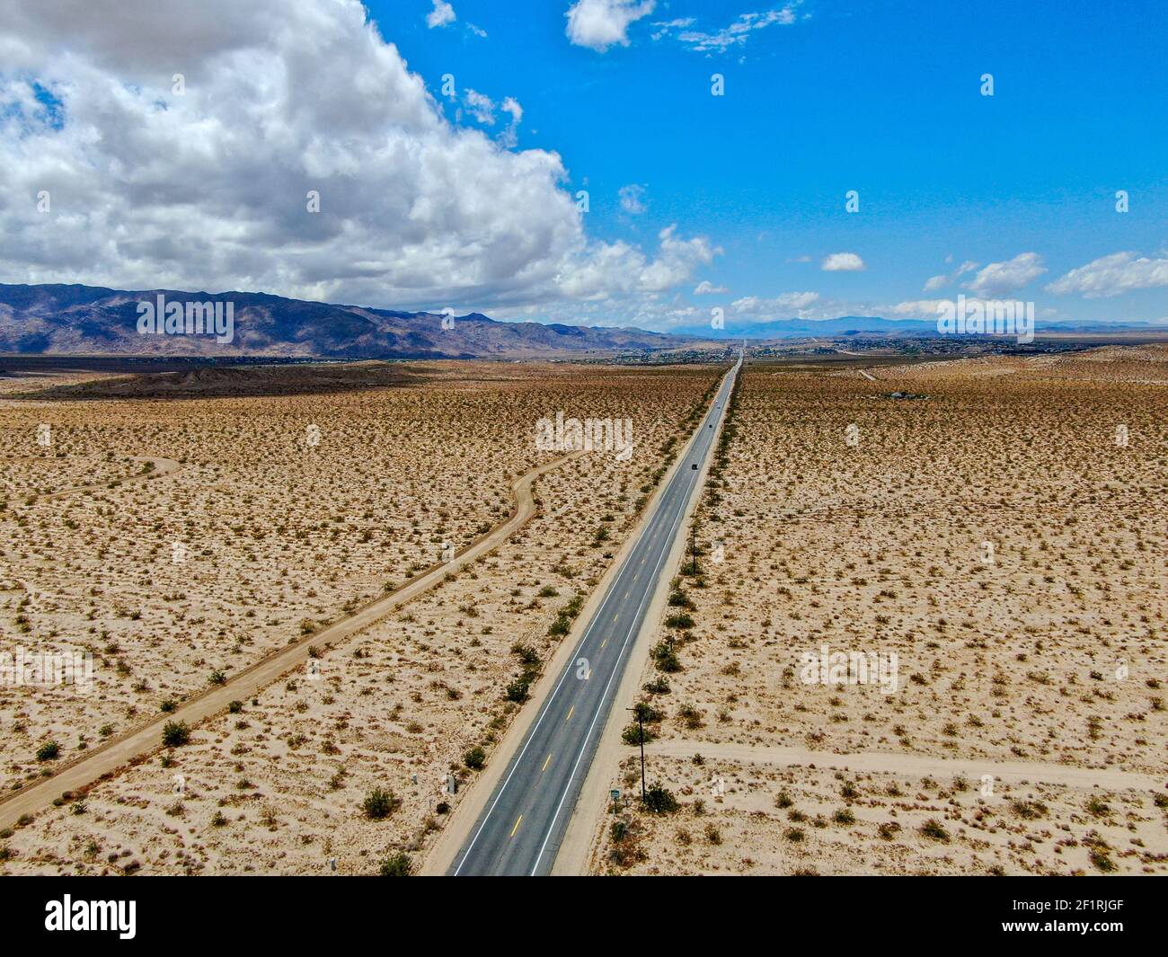 Aerial view of endless desert straight dusty asphalt road in Joshua Tree Park. USA. Stock Photo