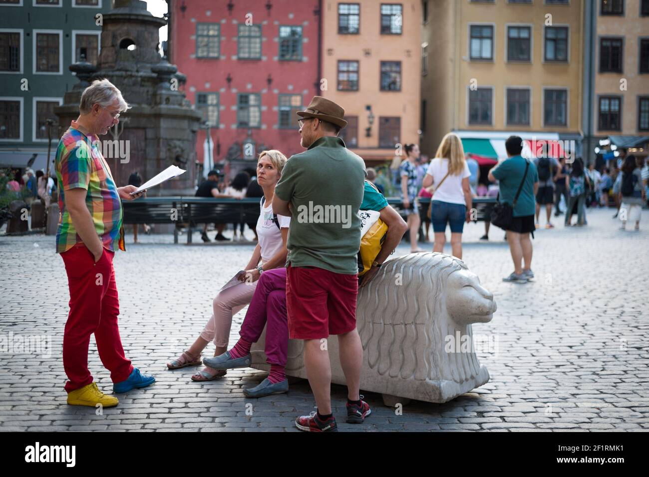 Colourful tourists in Stortorget, Gamla Stan, Stockholm, Sweden. Stock Photo