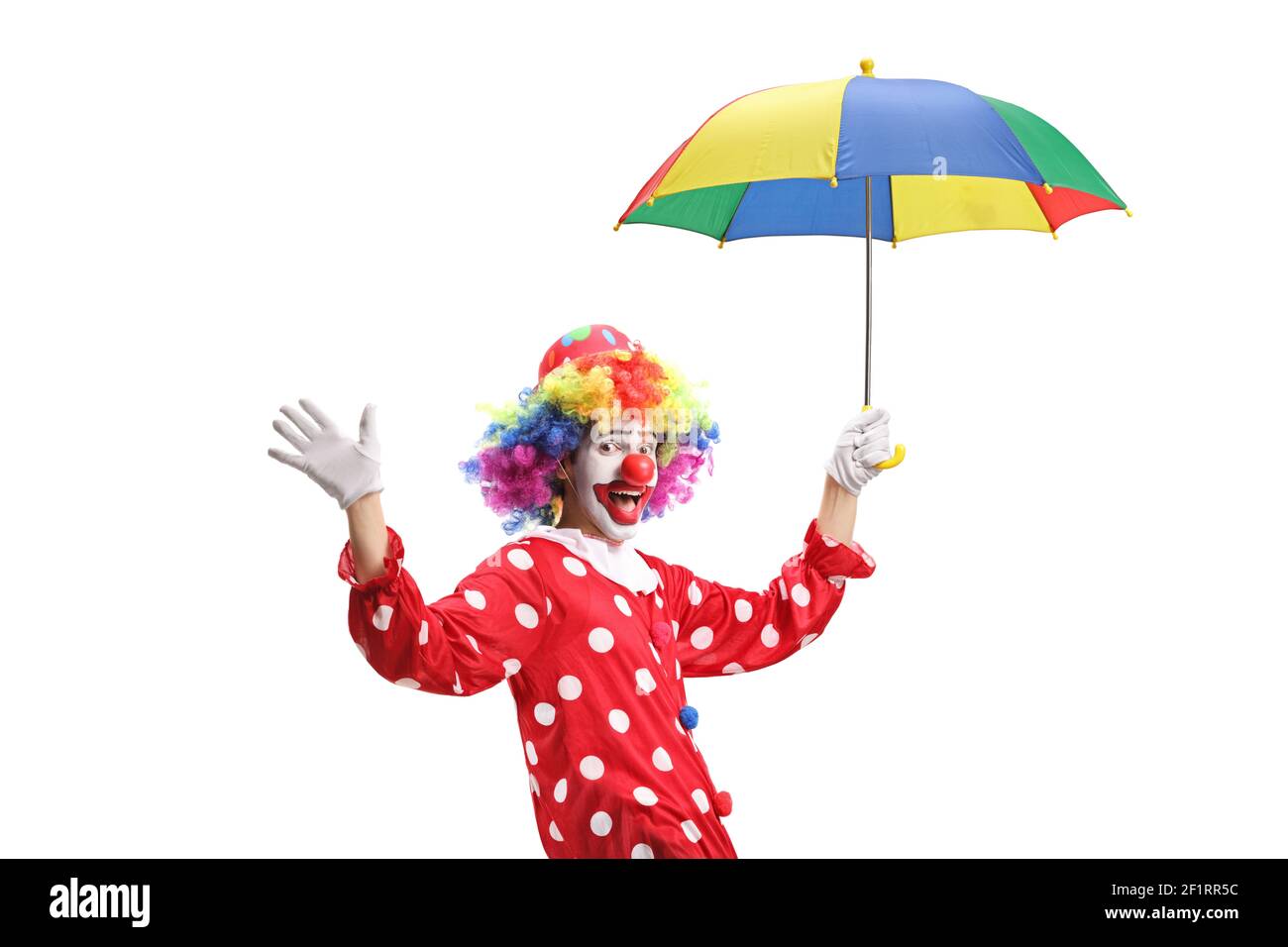 Clown waving and holding an umbrella isolated on white background Stock Photo