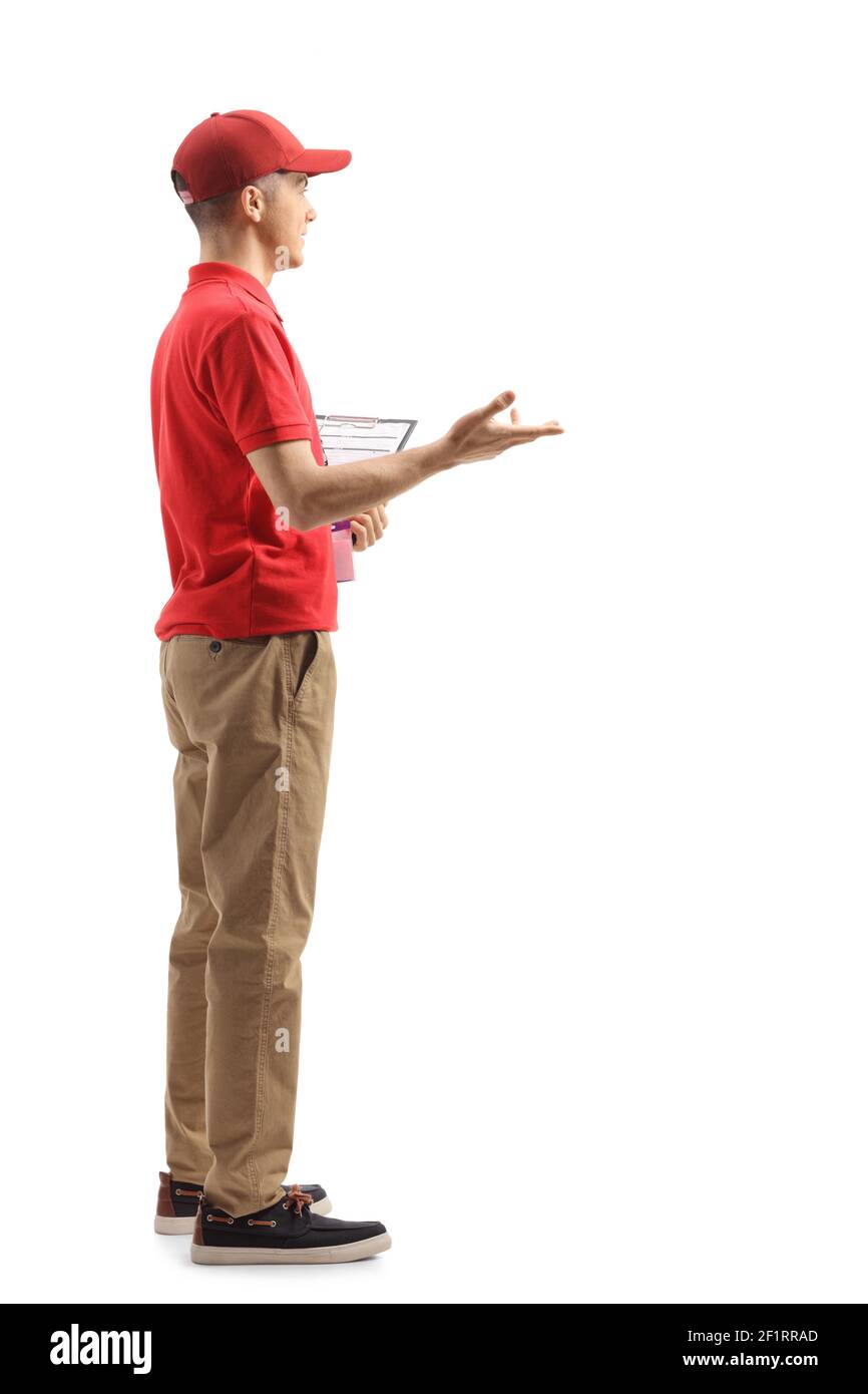 Full length ptofile shot of a male shop assistant gesturing with hand isolated on white background Stock Photo