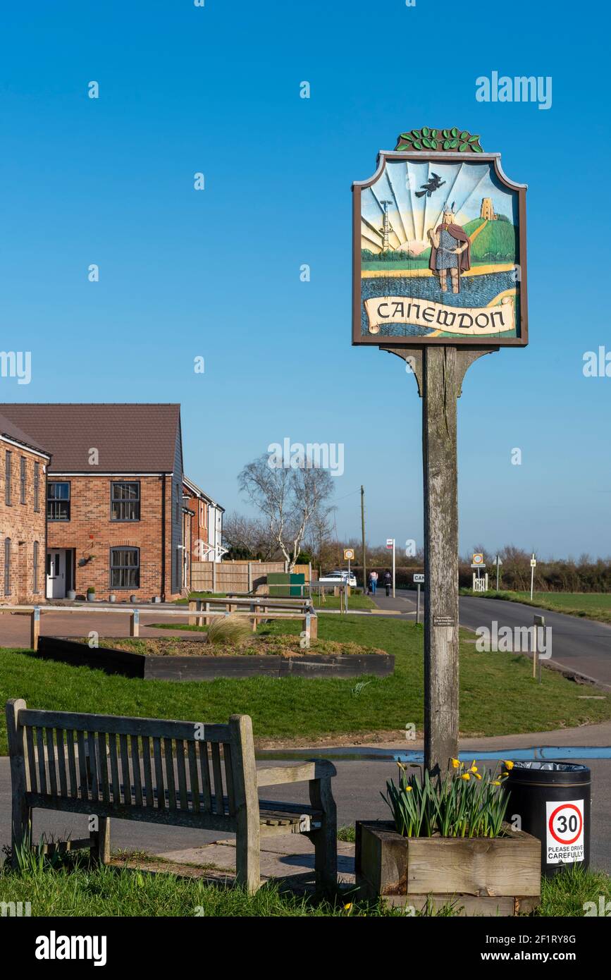 Canewdon village sign, with relief pictures of local history. A Viking figure from nearby Battle of Ashingdon. Modern housing development. Property Stock Photo