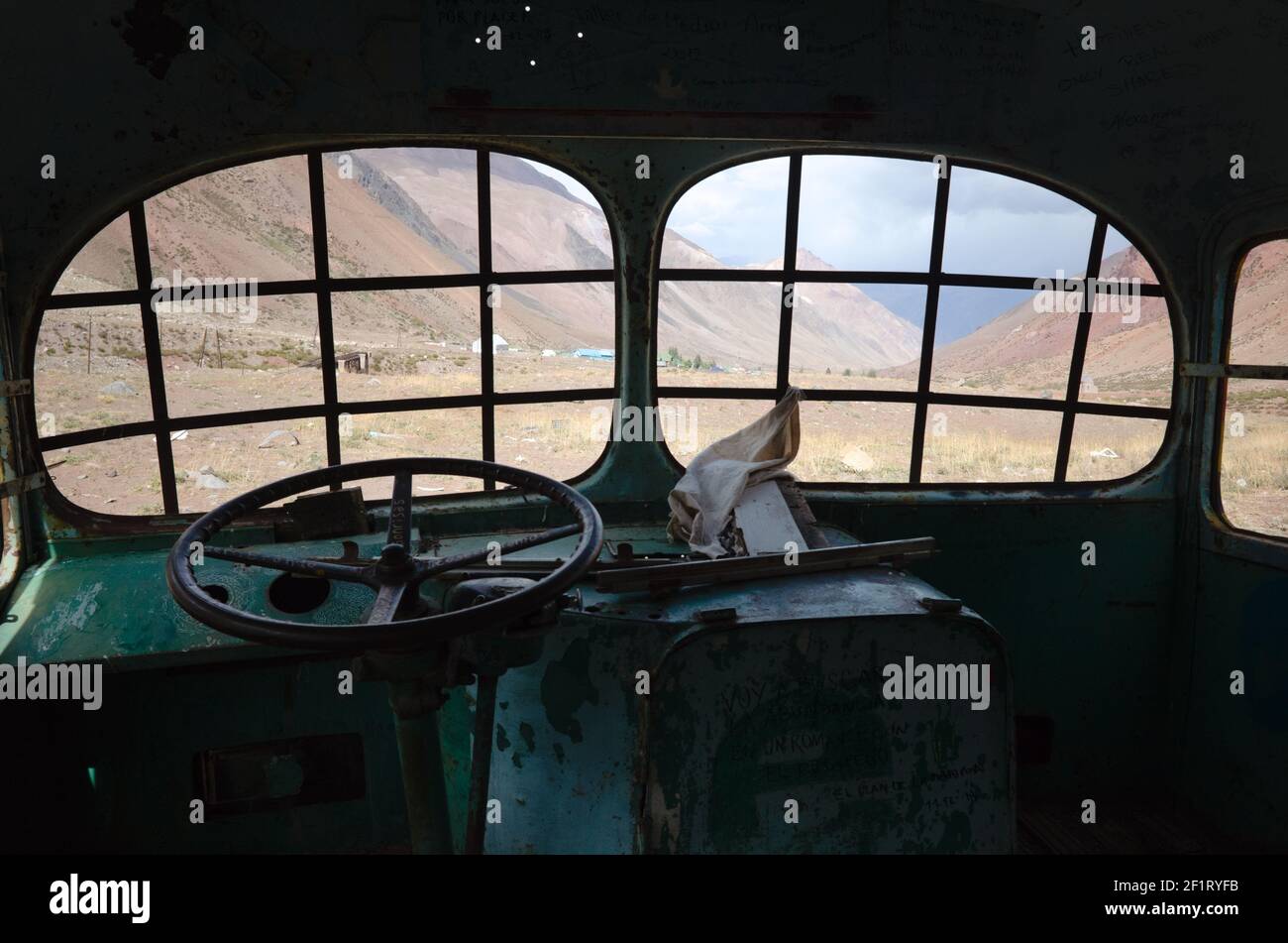 Interior of abandoned bus in a desert in Andes Mountains near Puente del Inca village, Mendoza province, Argentina Stock Photo