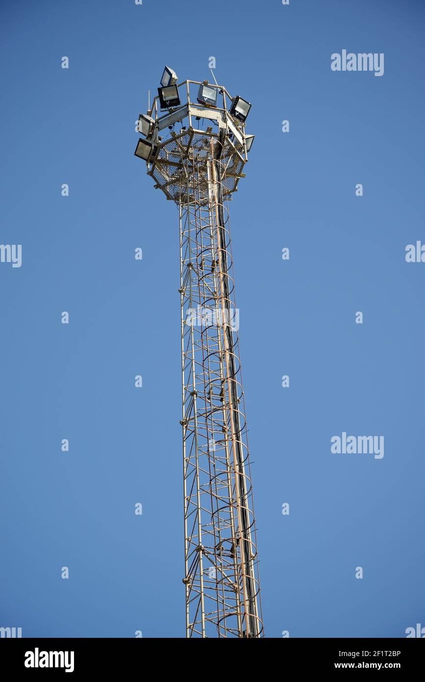A tall lighting gantry with high powered flood lighting modules in a circular array. Stock Photo