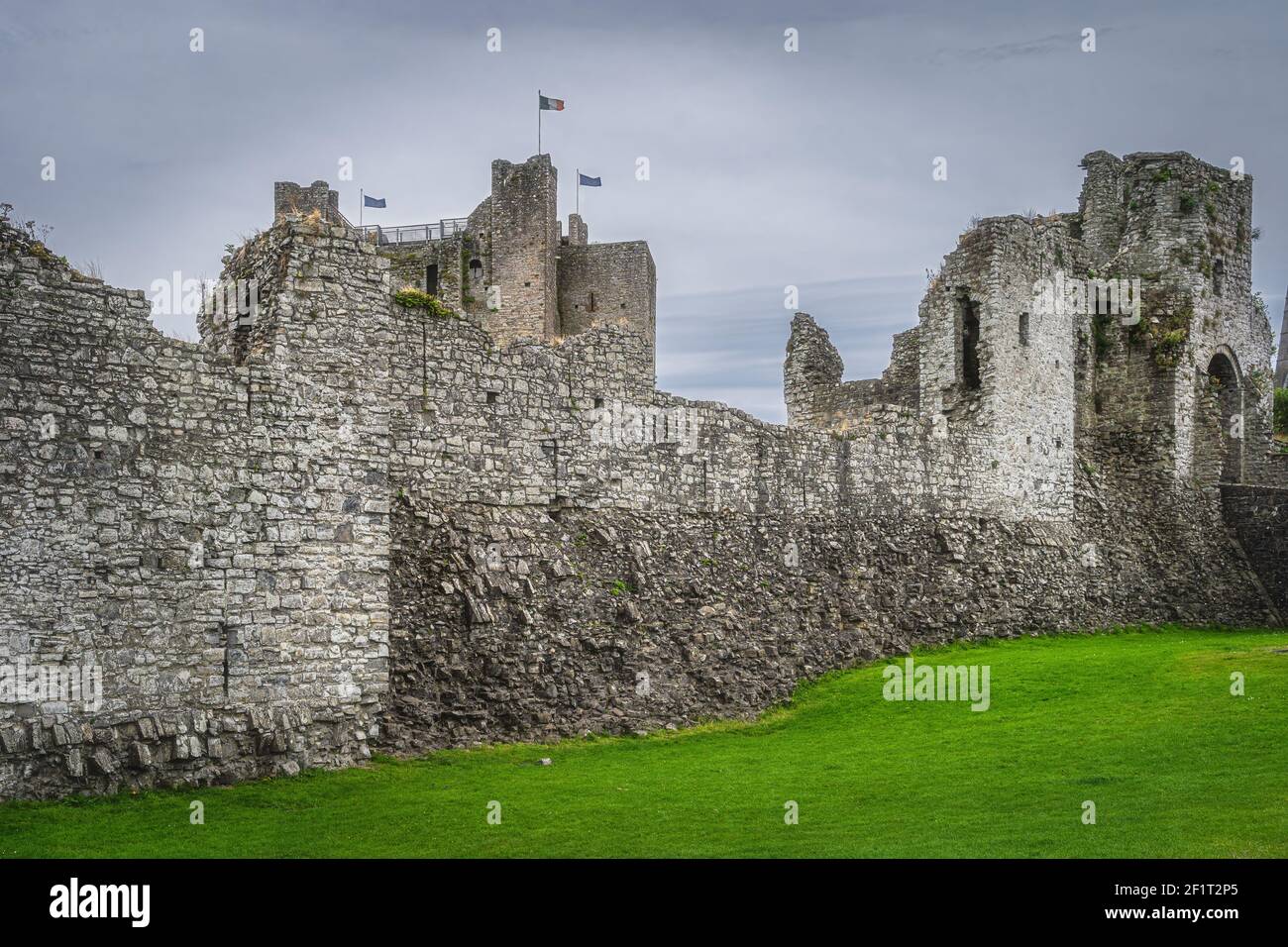 Ruined walls and fortifications of Trim Castle from 12th century with dark moody sky in Trim