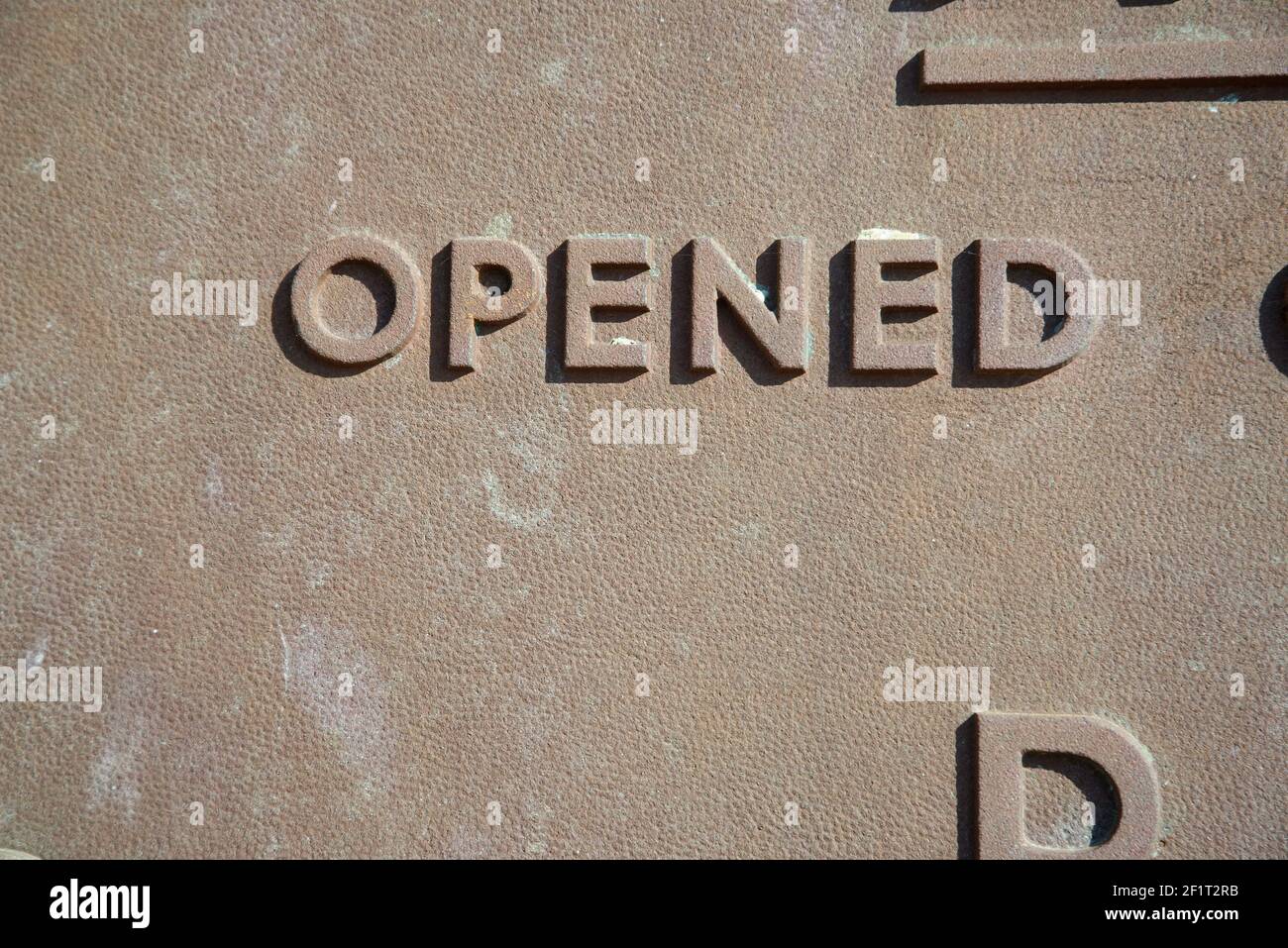 "Opened" word on a metal commemoration plaque. Stock Photo