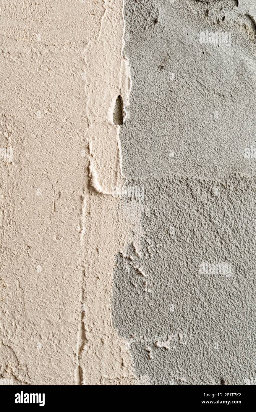 two-tone plaster. White plaster partially applied to a gray cement wall. Stock Photo