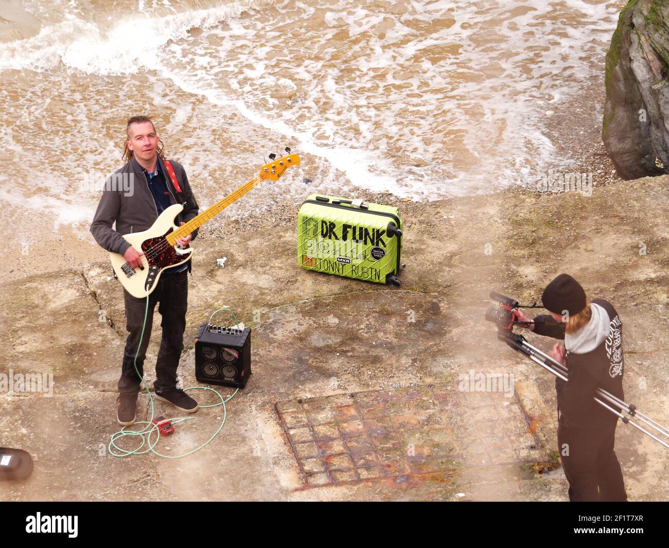 Newquay,Cornwall, 09th March 2021. You Tube sensation Jonny Rubin known as Dr Funk with 10 million plus views. Started as a busker in Newquay, here recording his latest video at Towan beach, Jonny born in California and raised in Sunderland makes his home in Cornwall. His fame is based on funky blues based bass guitar playing.  Credit: Robert Taylor/Alamy Live News” Stock Photo