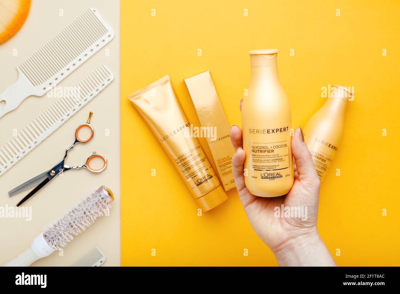 L'oreal professionnel Paris Serie Expert loreal nutrifier hair professional  products set scissors combs and hairdressing tools. Loreal shampoo in hand  Stock Photo - Alamy