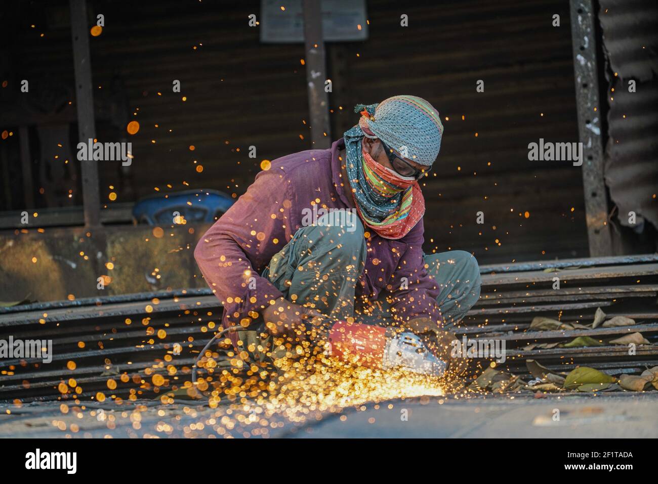 A worker weld to cut a part on steel structure with a blow torch at a