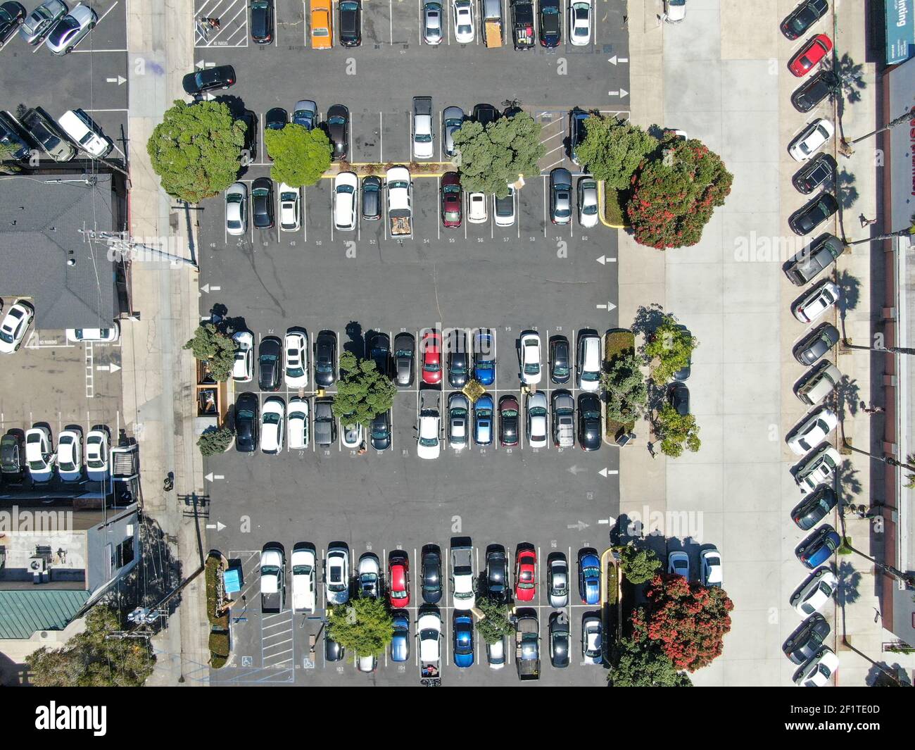 Aerial top view of parking lot with varieties of colored vehicles. Stock Photo