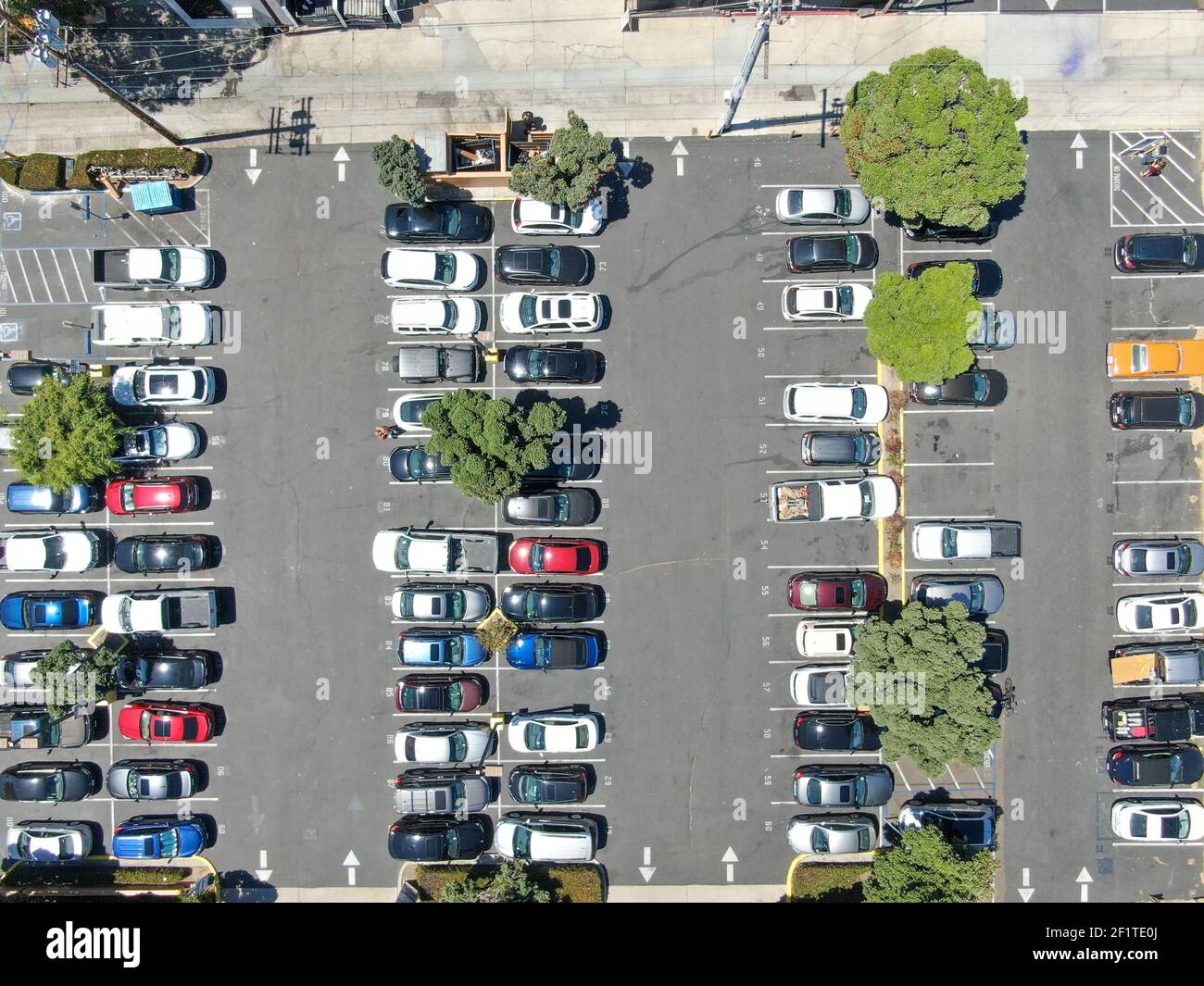 Aerial top view of parking lot with varieties of colored vehicles. Stock Photo