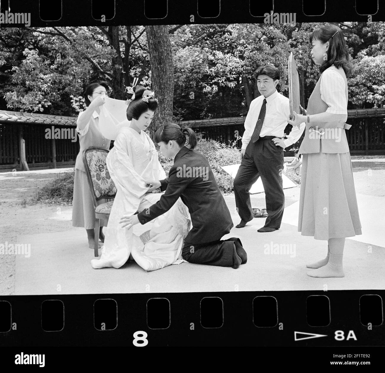 Shinto wedding couple man and woman holding mirror at religious ceremony in Japanese park in Tokyo , Japan . Stock Photo