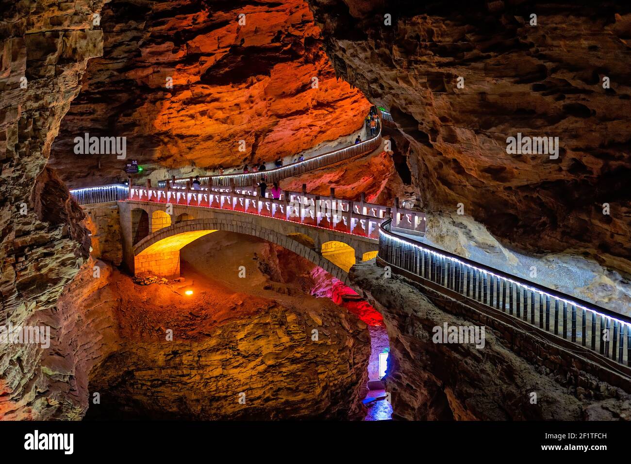 People sightseeing interior of magnificent  Huanglong Yellow Dragon Cave Stock Photo