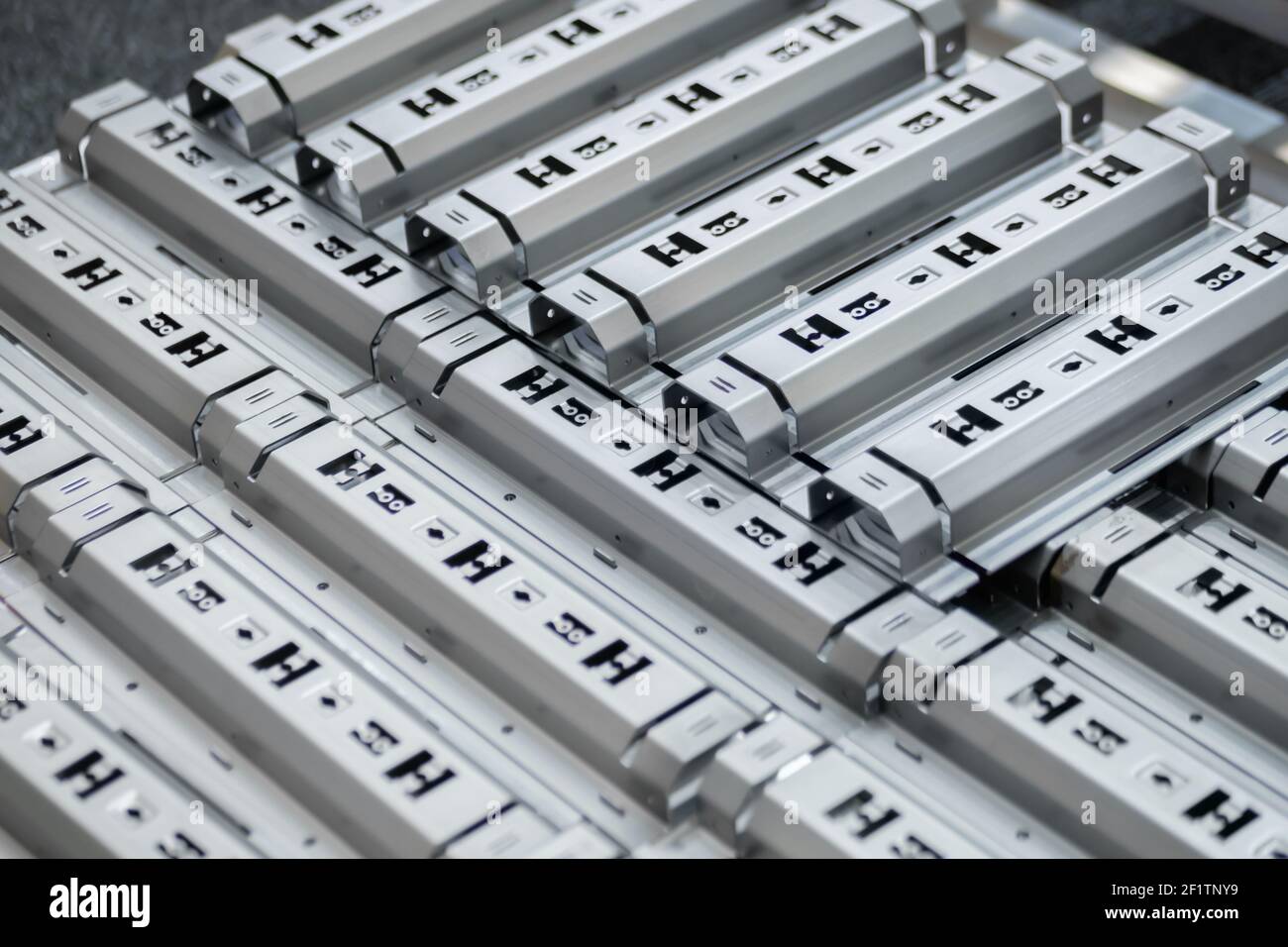 Metal workpieces with holes of different sizes after hydraulic punching process Stock Photo