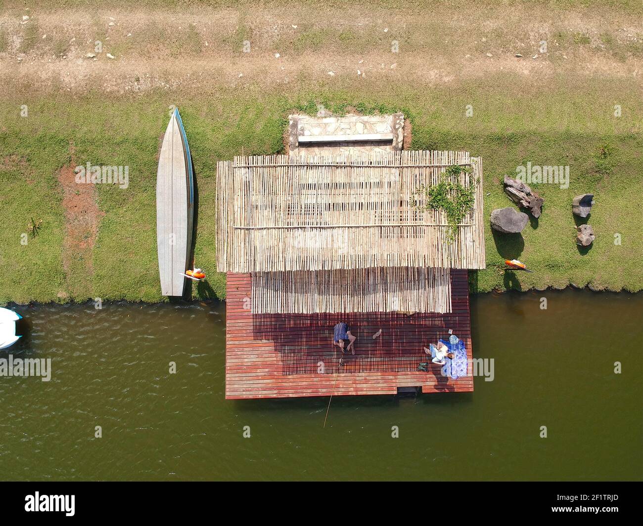 Aerial view of beautiful little wood cabana next the water of a lake, Stock Photo