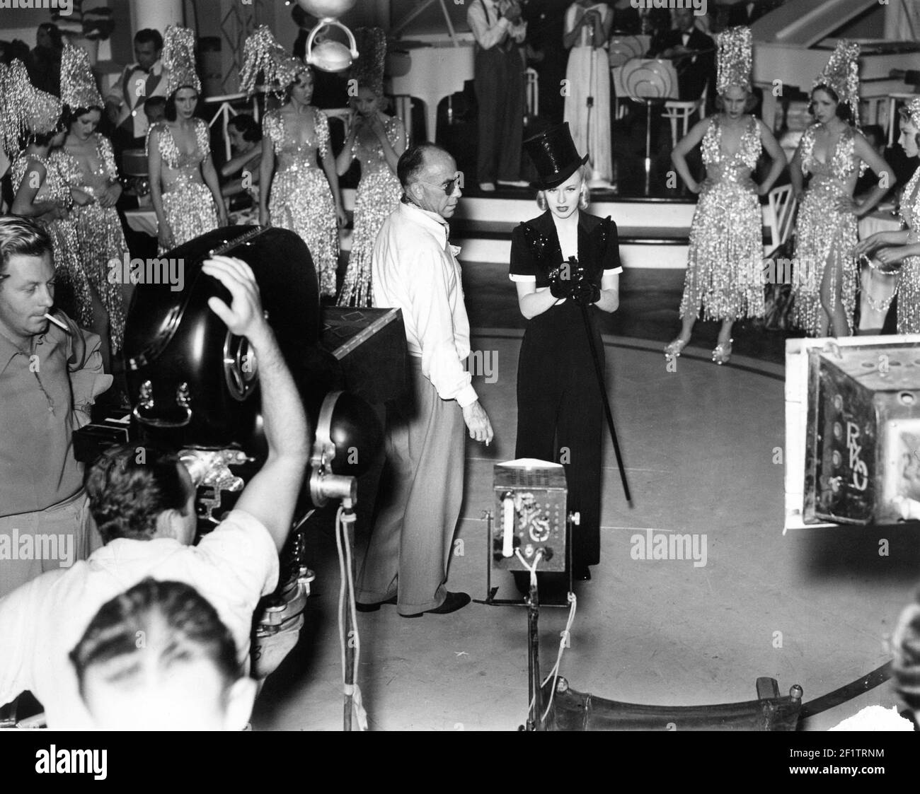 Director GREGORY LA CAVA and GINGER ROGERS on set candid filming musical number with dancers and camera crew during production of STAGE DOOR 1937 director GREGORY LA CAVA from the play by Edna Ferber and George S. Kaufman RKO Radio Pictures Stock Photo