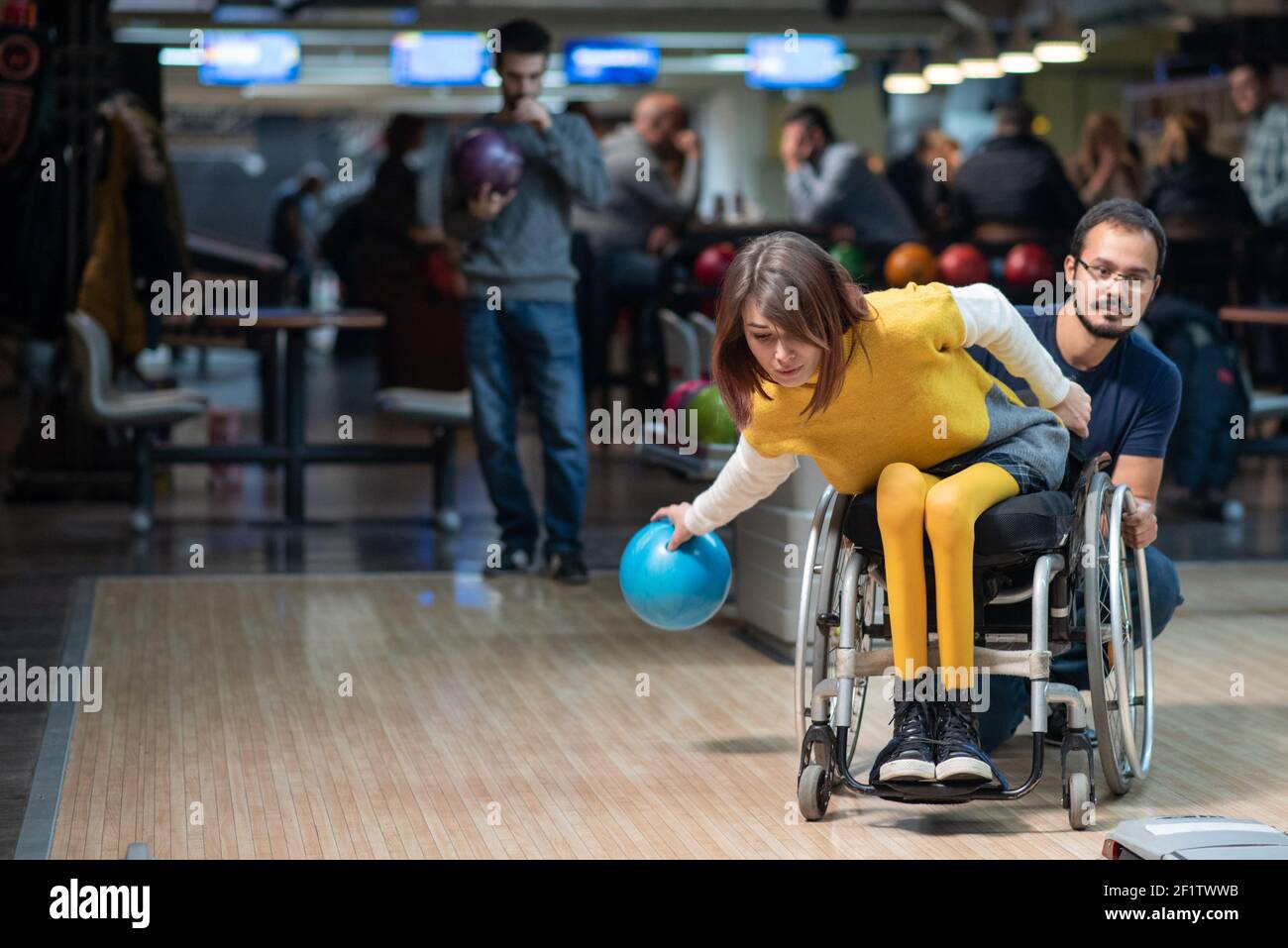 Young disabled woman in a wheelchair bowling Stock Photo