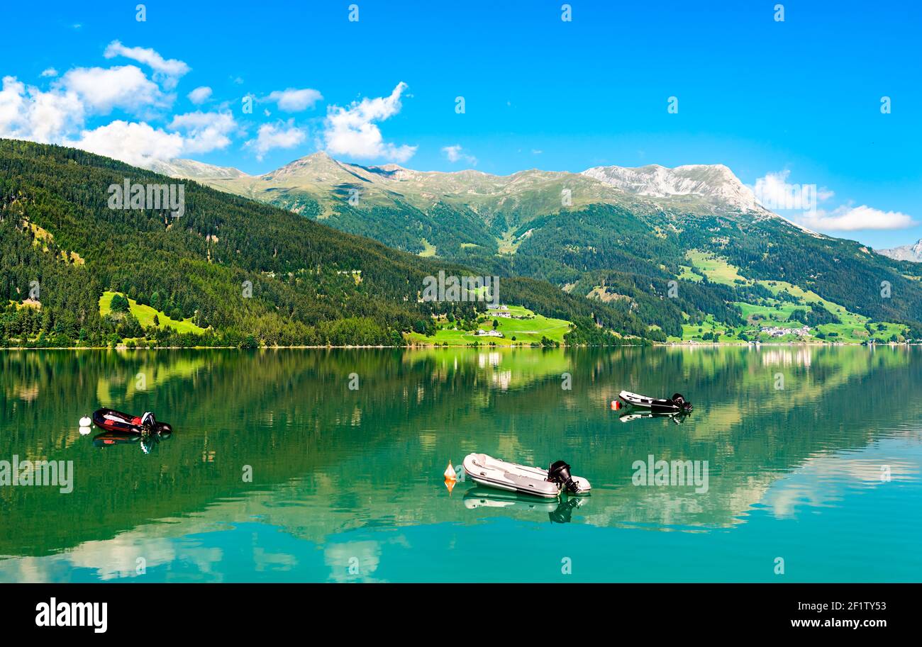 Boats on Reschensee, an artificial lake in the Italian Alps Stock Photo