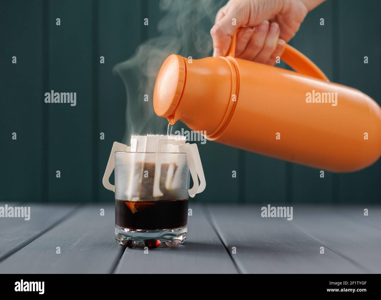 Making drip coffee with hot water from thermos front view Stock Photo