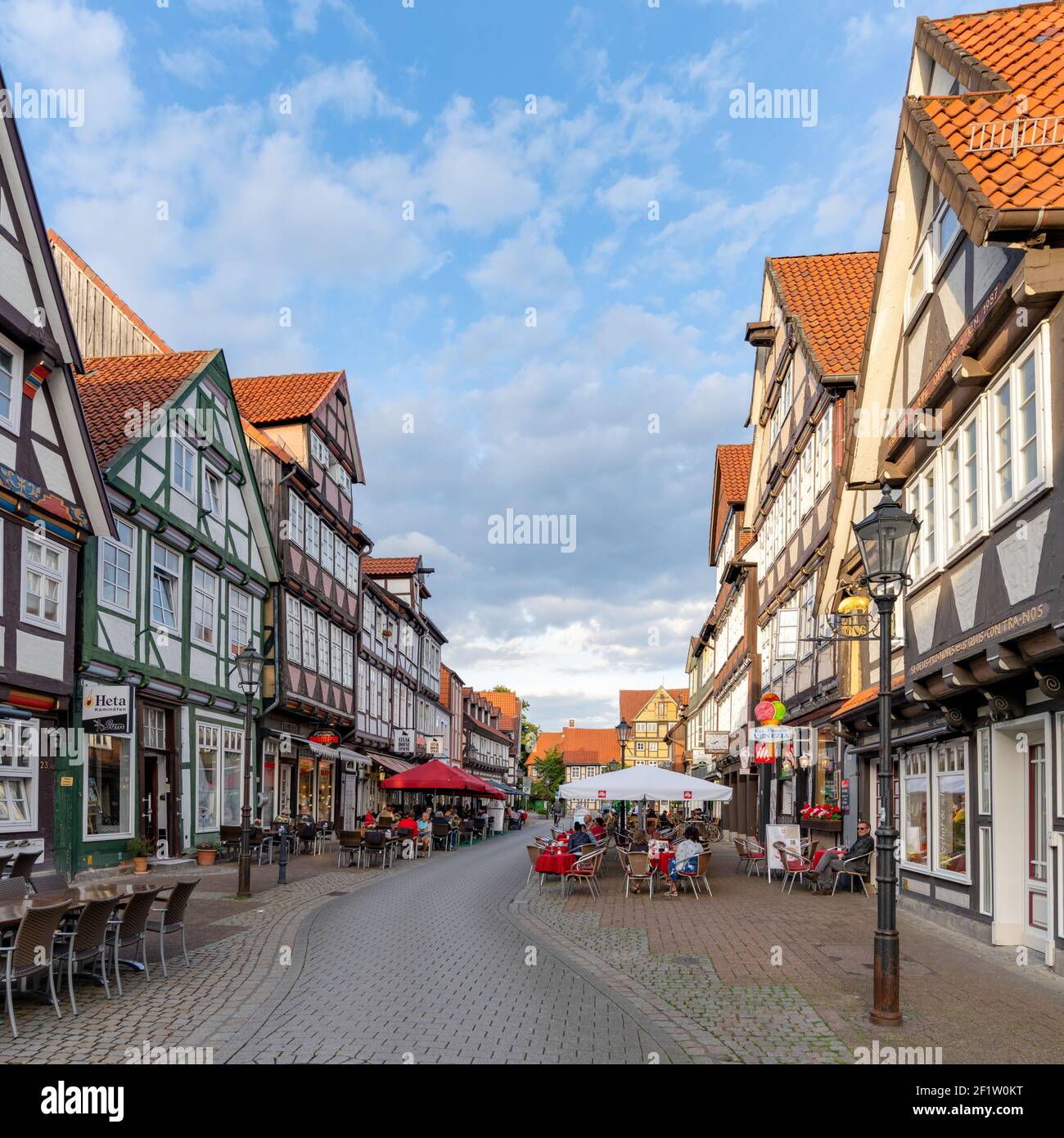 People enjoy a beautiful summer evening out in the streets of the historic old town of Celle Stock Photo