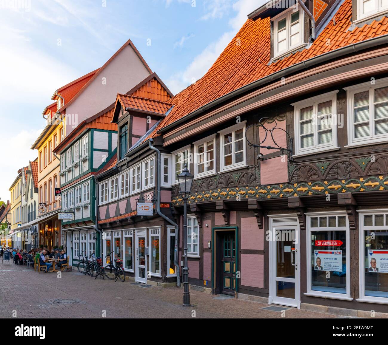 People enjoy a beautiful summer evening out in the streets of the historic old town of Celle Stock Photo