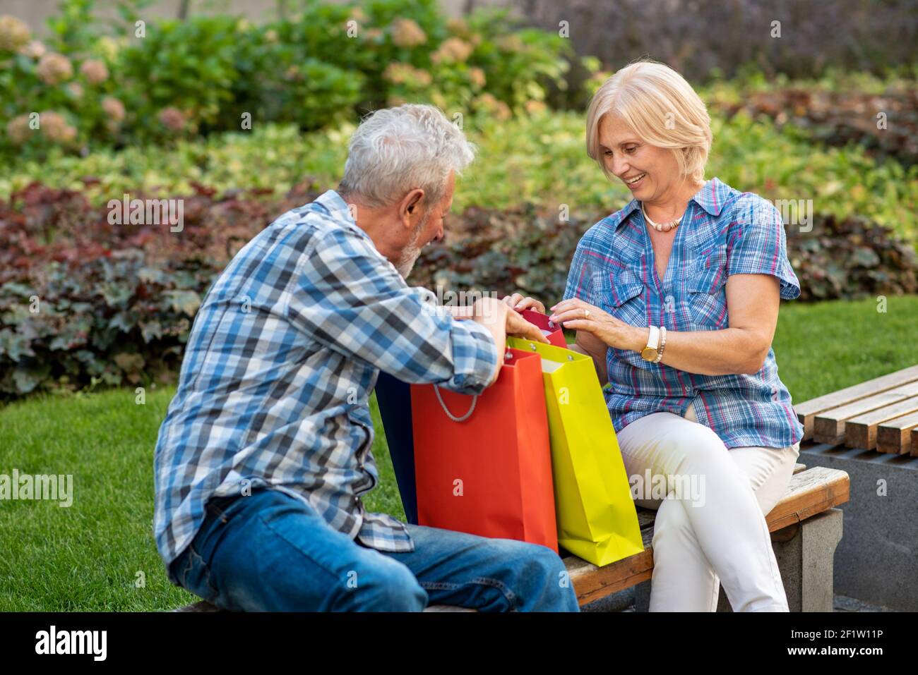 Happy senior couple with shopping bags after shopping Stock Photo