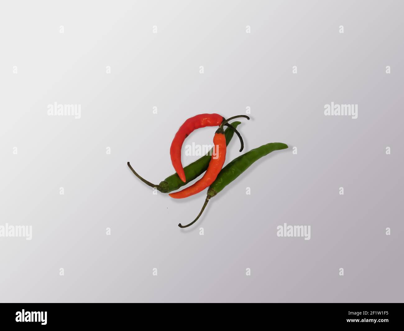 Green And Red Color Spicy Indian Chili In White Background Stock Photo