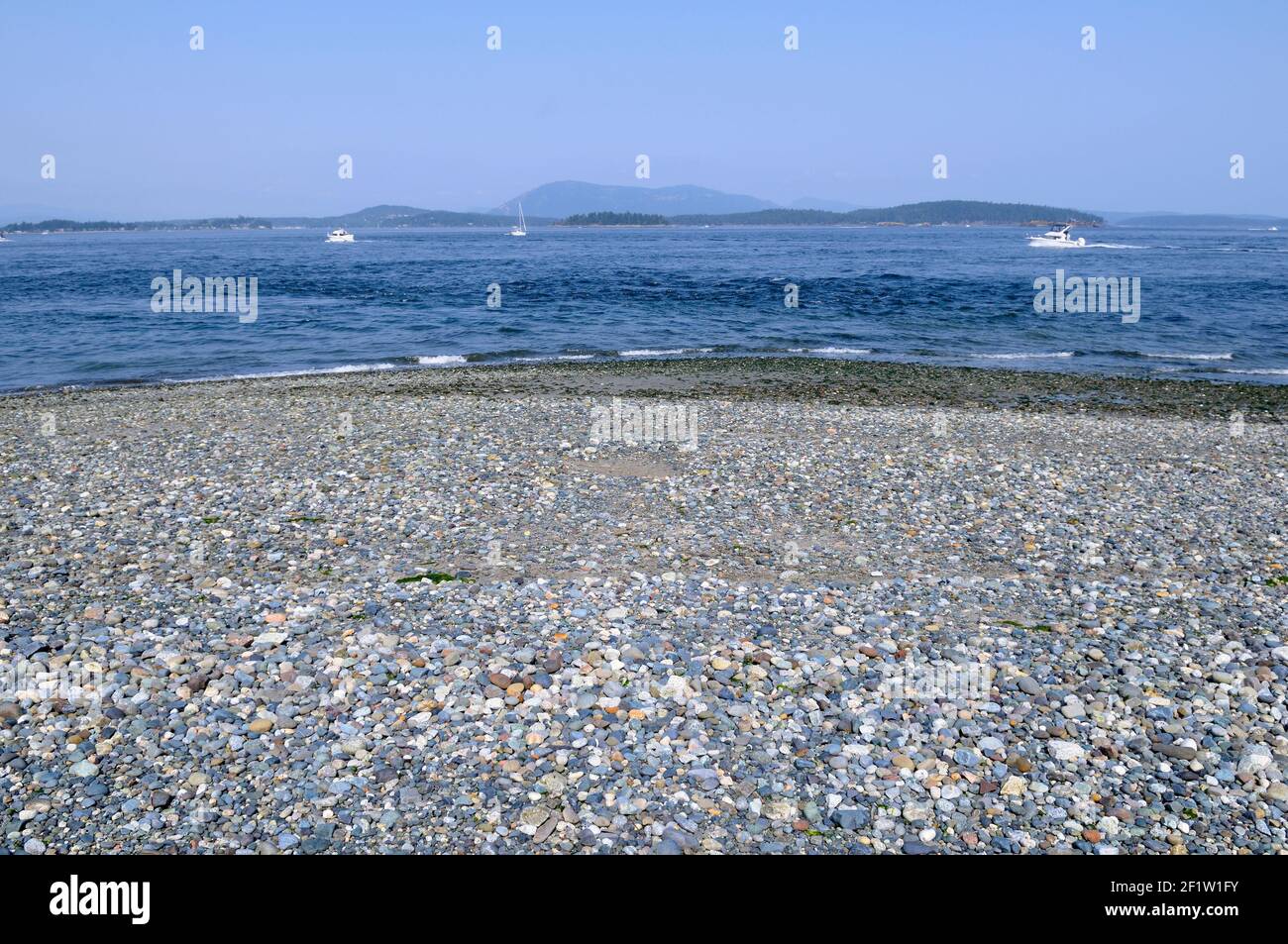 Spit With Rocks Colourful rocks on the beach at the end of Sidney Spit, Gulf Islands ...