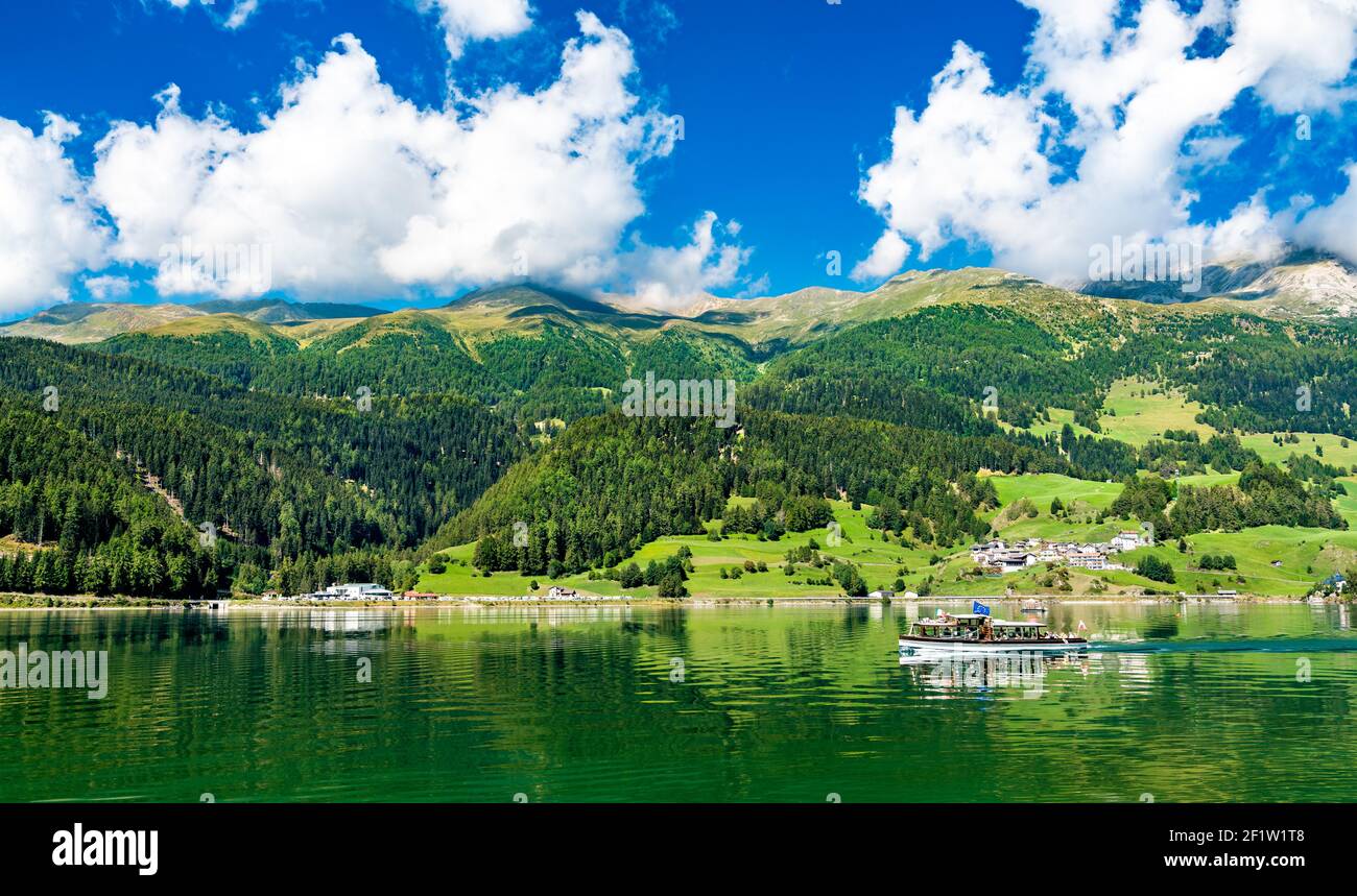 Boat on Reschensee, an artificial lake in the Italian Alps Stock Photo