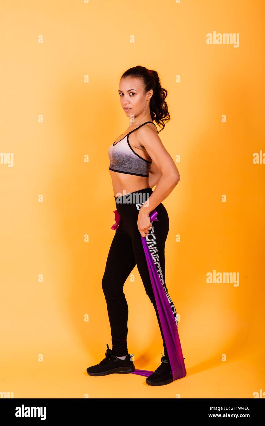 https://c8.alamy.com/comp/2F1W4EC/attractive-young-african-american-sports-fitness-woman-in-sportswear-working-out-isolated-on-red-background-sport-exercises-healthy-lifestyle-concept-2F1W4EC.jpg