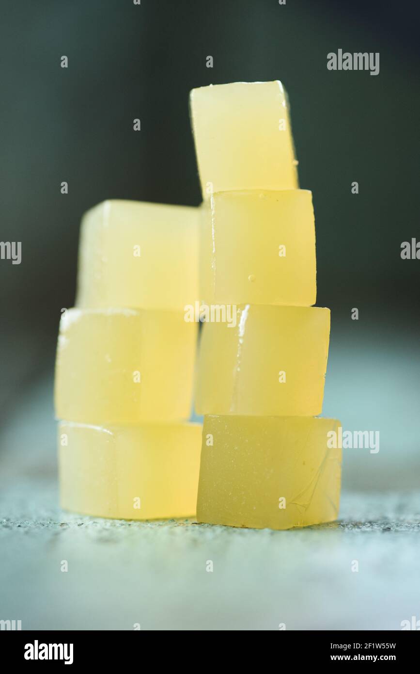 Vegan sweets. Stack of homemade agar fruit jelly cubes on rustic shabby