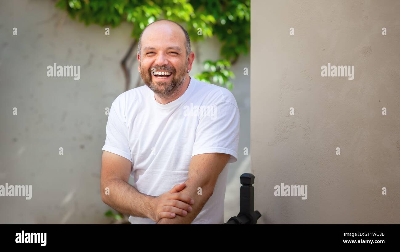 Bearded bald man laughing Stock Photo
