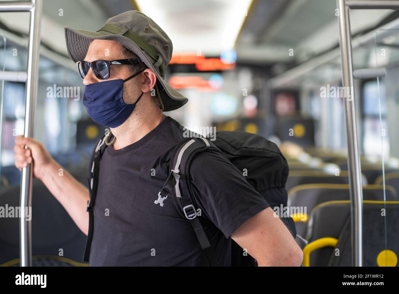 Man with a mask talking traveling in the train during Covid19 pandemic Stock Photo