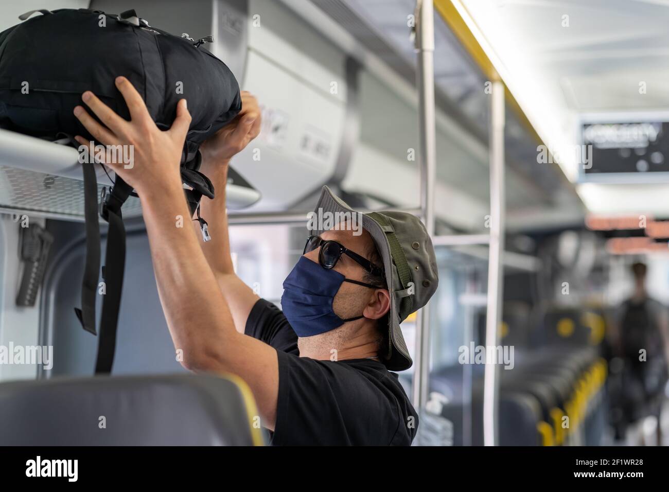 Man with a mask talking traveling in the train during Covid19 pandemic Stock Photo