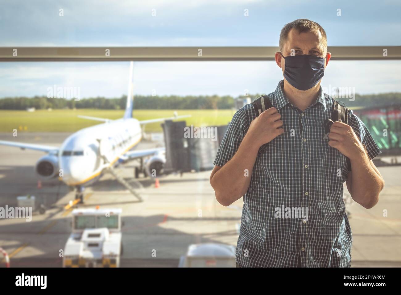 Man with a backpack waiting for departure in Covid19 time Stock Photo